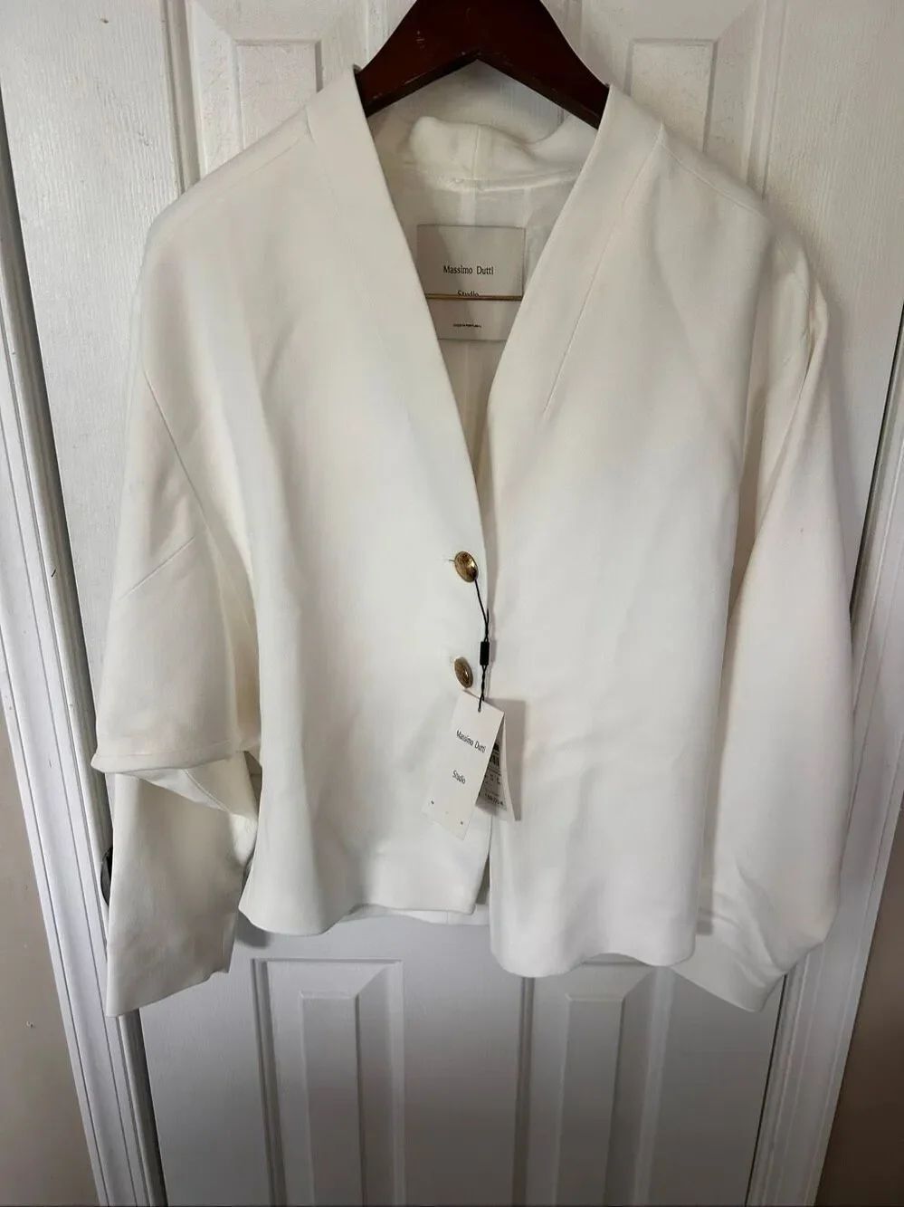 Massimo Dutti Studio white jacket features structured shoulders distinctive gol